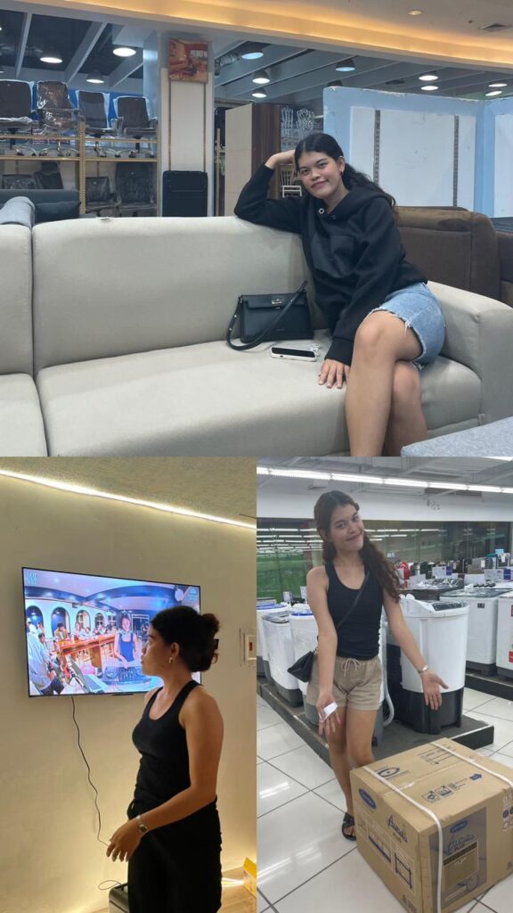 Amy shopping and building her life (sofa store, TV on wall, appliance store).